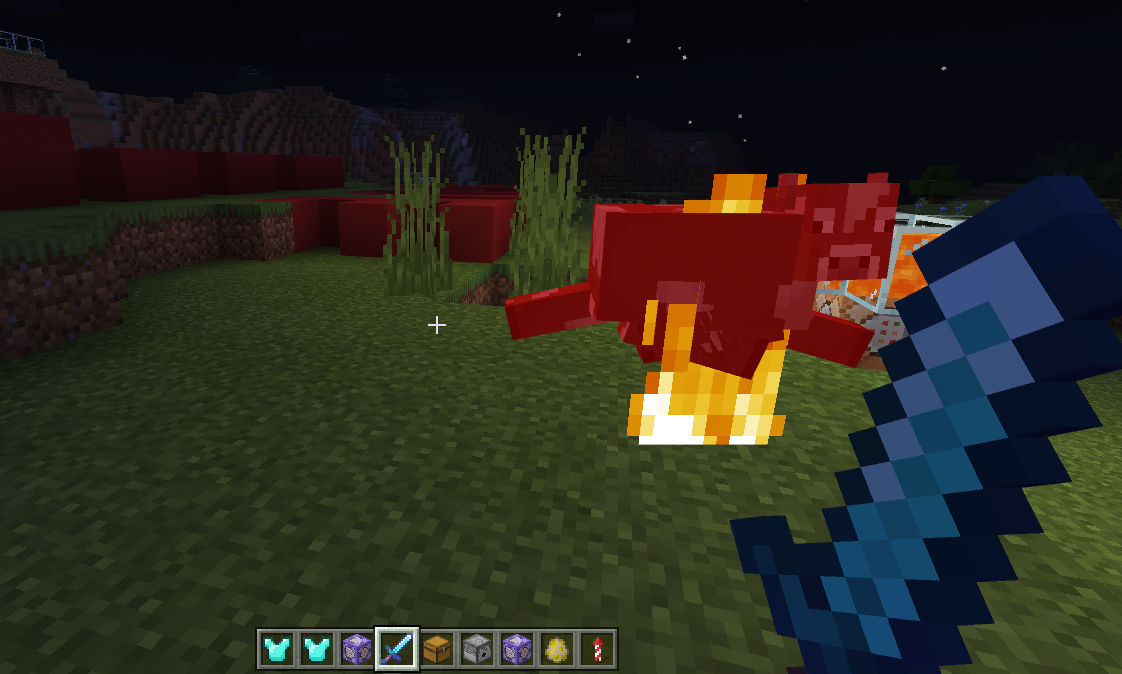 A cow is on fire after being hit by a sword enchanted with fire aspect.